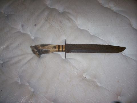 1993 Ford Bronco - A hunting knife with a textured blade and a handle made of bone or antler is shown.