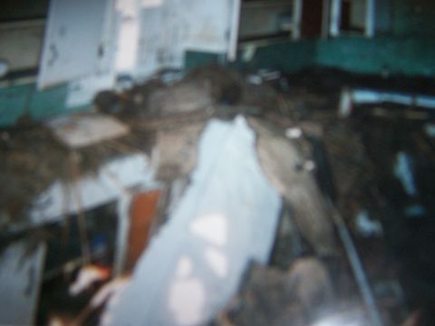 1993 Ford Bronco - The interior of a vehicle is filled with debris, obscuring most details.