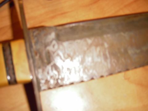 1993 Ford Bronco - A close-up view of a knife blade and its handle, showing signs of wear and tear.