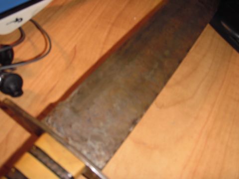 1993 Ford Bronco - A close-up view of a knife with a rusty blade and a wooden handle.
