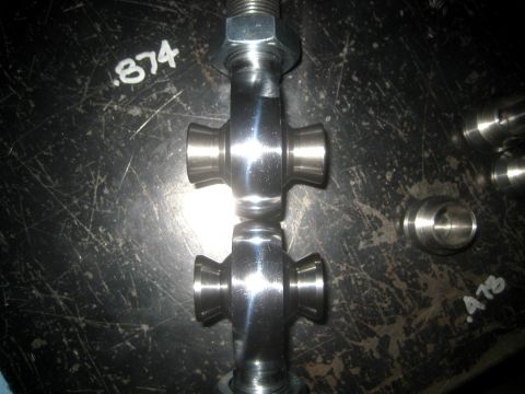 1996 Ford Bronco - Close-up of two metal universal joints with visible markings on the surface.