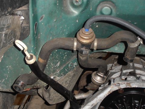 1990 Ford Bronco - Engine bay hoses and valves are visible in this close-up shot.