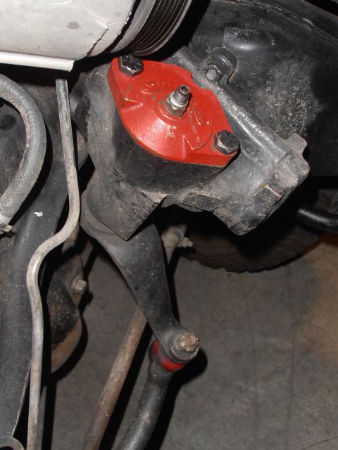 1990 Ford Bronco - Close-up view of a vehicle's steering box and associated linkage components.