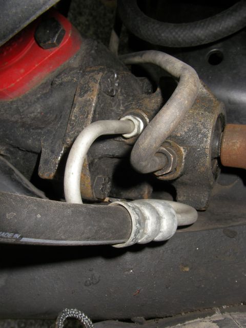 1990 Ford Bronco - Power steering gearbox and associated hoses, likely from a truck or SUV.