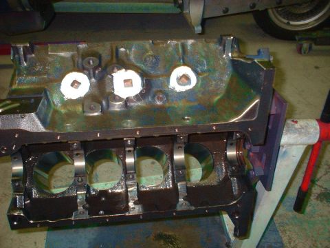 1957 Ford Custom Sedan - Close-up of an engine block, possibly undergoing rebuild or repair, with visible bearing surfaces.