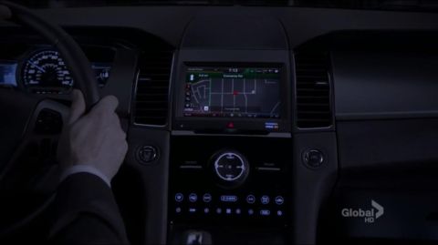 1993 Ford Taurus - Interior view of a car's dashboard at night, displaying a GPS navigation system and illuminated controls.