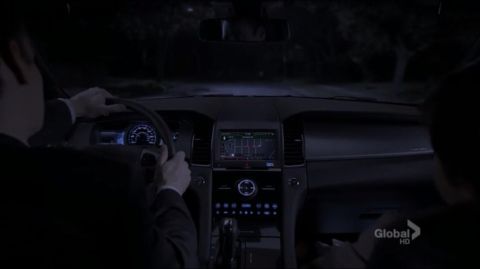 1993 Ford Taurus - The interior of a car is shown at night, with the GPS navigation system active on the dashboard screen.