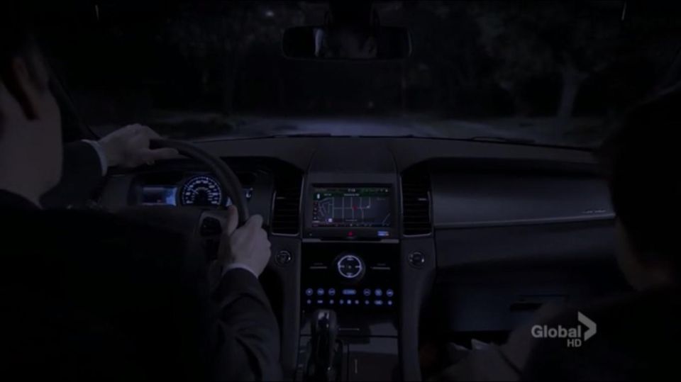 Car interior at night with GPS screen and illuminated dashboard