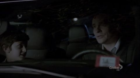 1993 Ford Taurus - Two people are inside a car at night, with one driving and the other looking on.