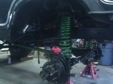 1979 Ford Bronco - This photo shows the suspension system of a vehicle undergoing modifications, with prominent green coil springs.