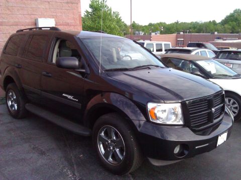2007 Dodge Durango - A black SUV is parked in a lot, showing its front and side profile with other vehicles nearby.