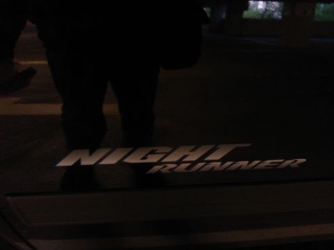 2007 Dodge Durango - Emblem reads 'Night Runner' on a dark surface, possibly a vehicle part.
