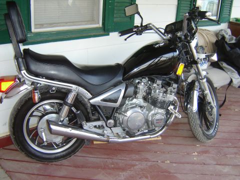 1982 Yamaha XJ7Maxim - Side view of a 1982 Yamaha XJ7Maxim motorcycle parked on a wooden deck.