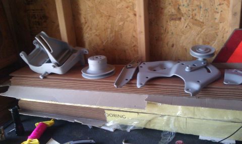 1986 Ford Bronco - Bracketry after being sandblasted and primered. Left to right: smog pump bracket, water pump pulley, ac mounting bracket, ac tensionor brac…