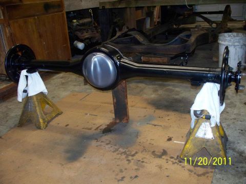 1990 Ford Bronco - A rear axle assembly is shown supported by jack stands in a workshop setting.