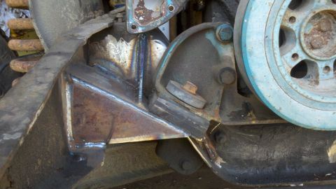 1993 Ford F-350 - Engine component detail with a light blue pulley and metal bracketry.