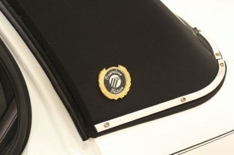 2004 Mercury Grand Marquis - Close-up of the 'Executive Edition' badge on the vinyl top of a 2004 Mercury Grand Marquis.