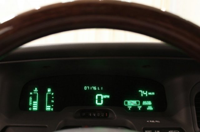 Dashboard gauges showing 0 mph, 74 miles, fuel, and temperature. Steering wheel visible