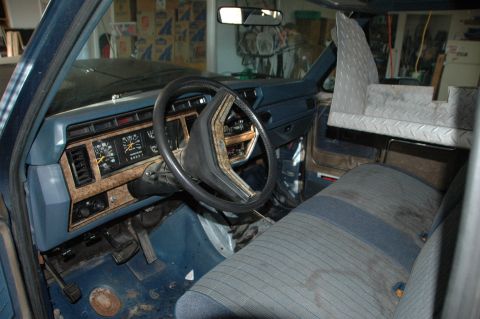1986 Ford Bronco - The dashboard gauges and wood grain trim are visible in this interior shot of a truck or SUV.