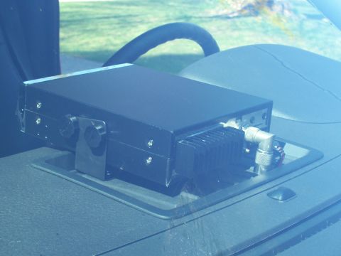 1978 Ford F-150 - A black CB radio is installed on the dashboard of a vehicle, with its rear connectors and a heat sink clearly visible.