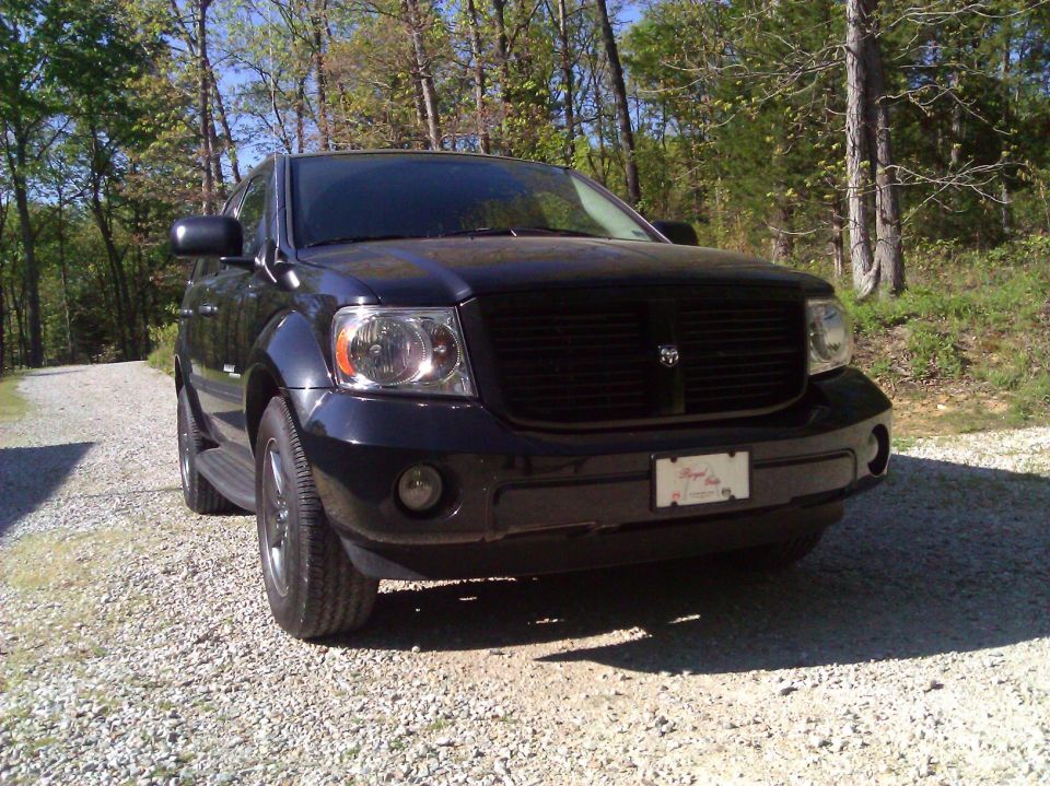 Front view of a black Dodge Durango parked on a gravel driveway