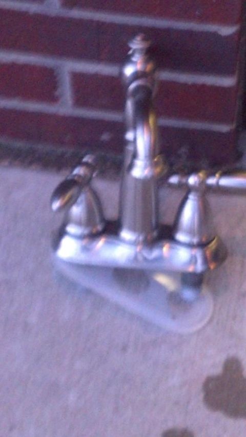 2000 Mercury Grand Marquis - A close-up of a chrome faucet, likely a replacement part, with a brick wall in the background.