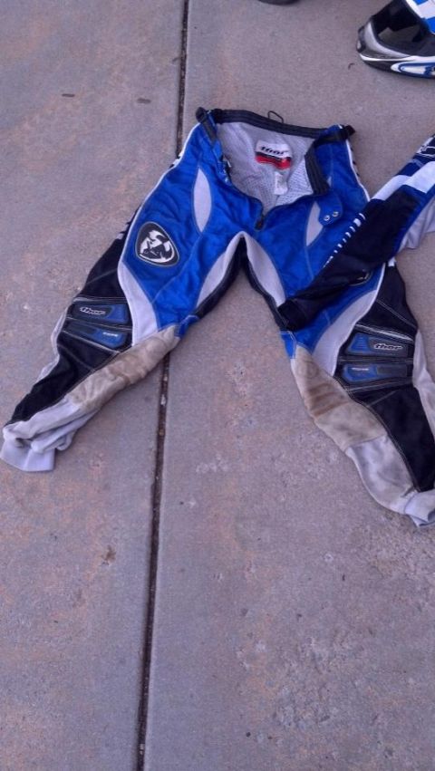 2000 Mercury Grand Marquis - Motocross pants are laid out on a concrete surface.