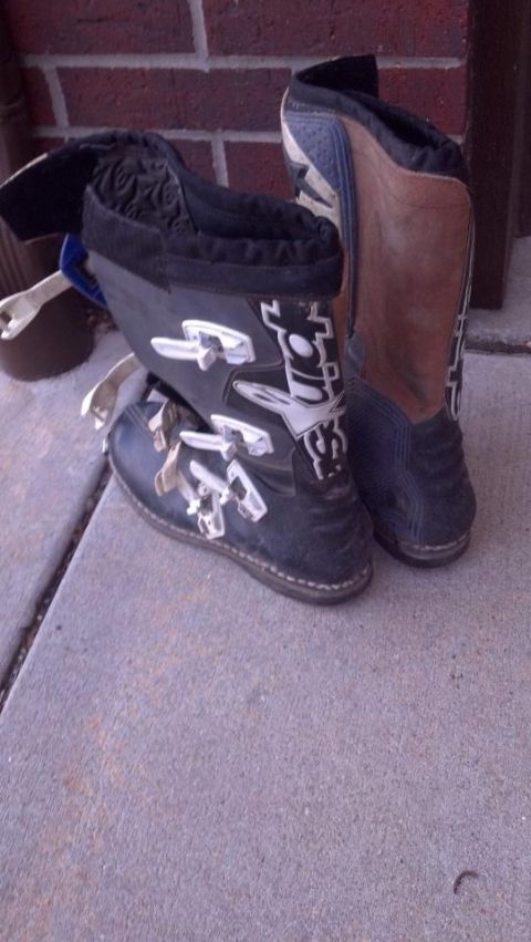 2000 Mercury Grand Marquis - A pair of black and brown motorcycle boots with white buckles are shown resting on a concrete surface.