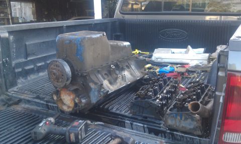 1978 Ford Bronco - Engine components are seen loaded in the bed of a Ford pickup truck.