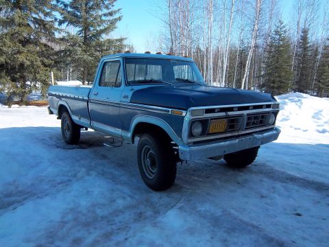 1978 Ford F-250 - This 1977 Ford F-150 pickup truck features a distinctive two-tone paint scheme with blue and dark blue sections.
