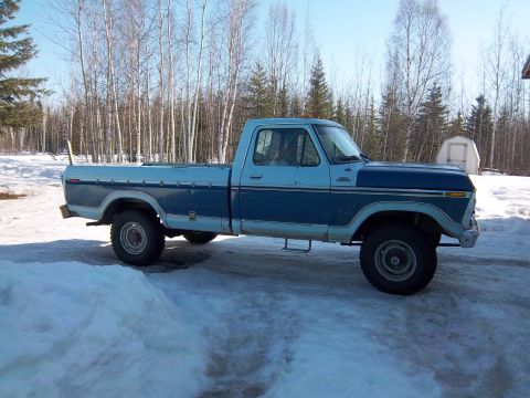 1978 Ford F-250 - This two-tone Ford pickup truck is parked in a snowy, wooded area.