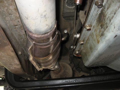 1994 Ford Bronco - Underside view of a vehicle's exhaust system, focusing on the catalytic converter and piping.