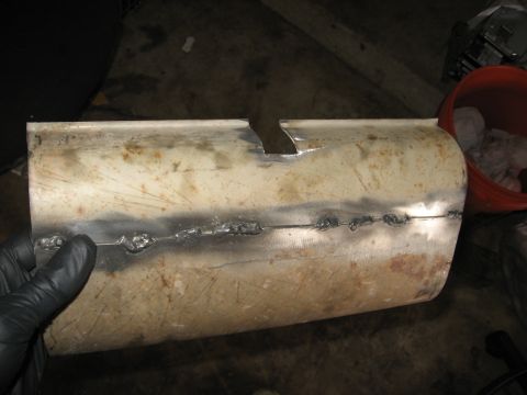 1994 Ford Bronco - A section of exhaust pipe shows evidence of repair with visible welds and a cut section.