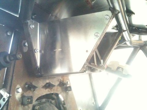 1966 Ford Bronco - Close-up view of custom metal work within a vehicle's interior, with visible bolts and supports.