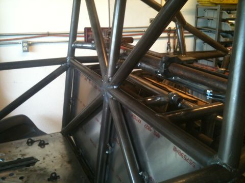 1966 Ford Bronco - Close-up view of custom roll cage fabrication with visible tubing and metal panels.