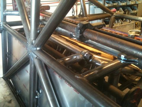 1966 Ford Bronco - A complex metal tube chassis is shown from a close-up perspective, with visible welding and sheet metal components.