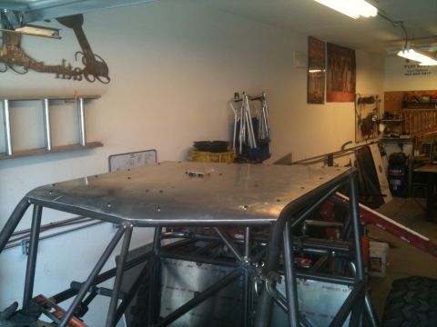 1966 Ford Bronco - A custom buggy frame is under construction in a garage, with tools and equipment visible in the background.