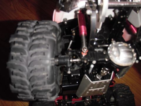 1993 Ford Bronco - Close-up view of a remote control car's undercarriage, showing its suspension and large off-road tires.