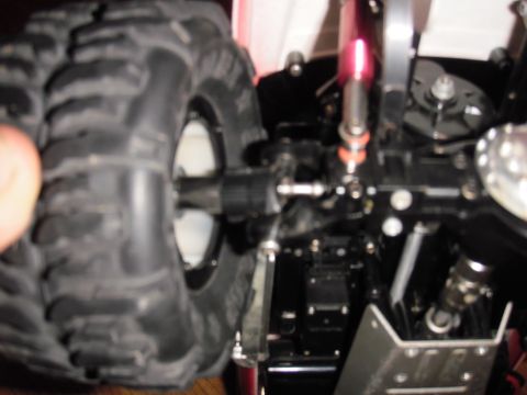 1993 Ford Bronco - Detail of a remote control car's chassis and tire, a visible "SUPERMOTORS" logo.
