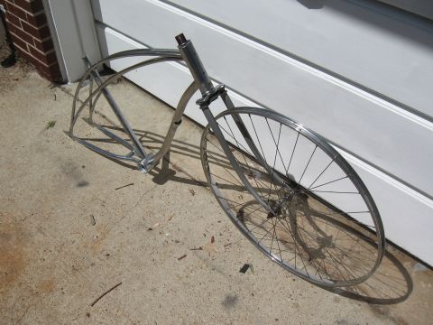 1994 Ford Bronco - A vintage bicycle frame and front wheel assembly rests on a concrete surface.