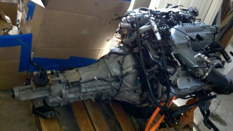 2004 Ford Crown Victoria - Engine and transmission assembly, likely a V8 with a supercharger, is displayed on pallets.