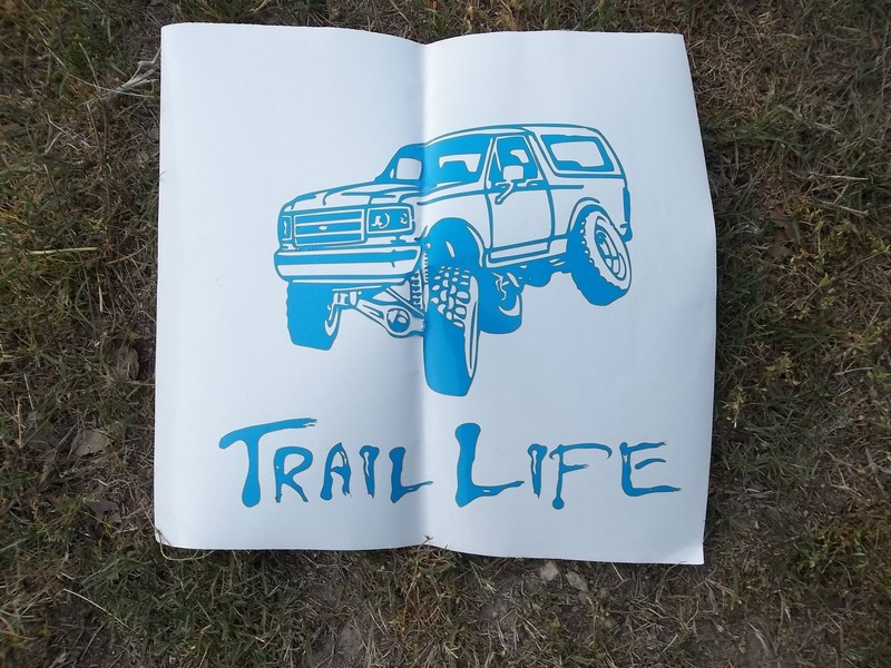 Blue graphic of a lifted Ford Bronco and the words 'TRAIL LIFE' on a white paper