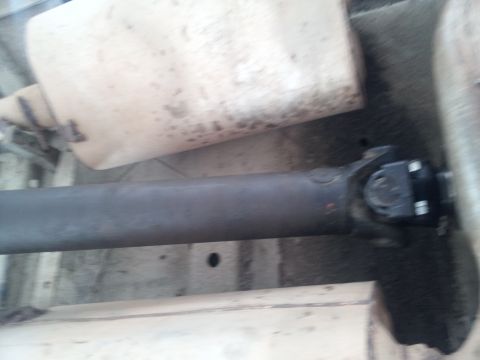 1978 Ford Bronco - Close-up view of a vehicle's driveshaft and muffler system.