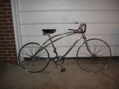 1994 Ford Bronco - A vintage-style chrome cruiser bicycle is shown parked in front of a garage door.