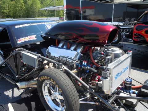 1982 Chevrolet Camaro - Custom drag car's V8 engine and front wheel assembly, with a second vehicle in the background.