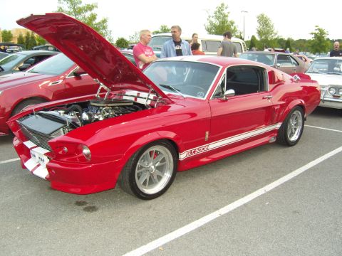 2007 Ford Mustang - Red 1967 Ford Mustang GT500 parked in a lot with hood open.