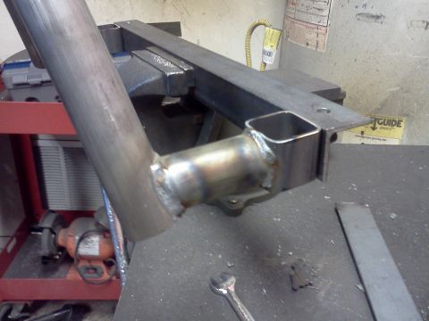 1999 Ford Ranger - A close-up view of a metal exhaust pipe section being welded and secured in a vise.