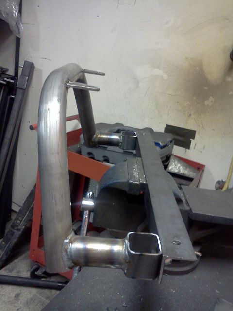 1999 Ford Ranger - A custom exhaust pipe section is clamped in a vise, likely for fabrication or repair.