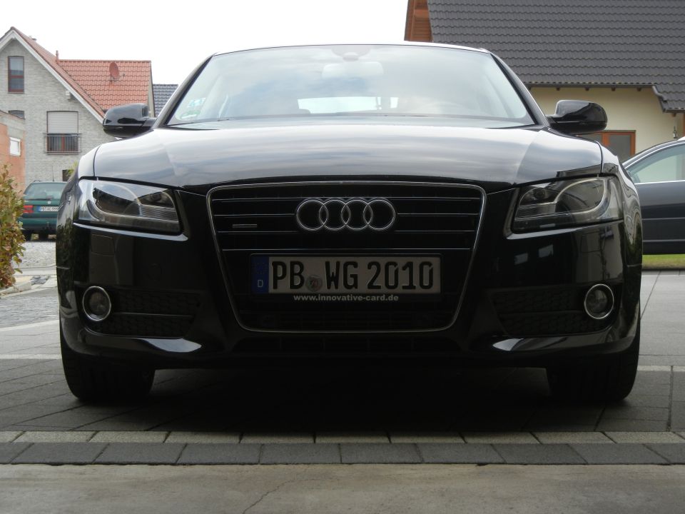Front view of a black 2010 Audi A4 sedan with license plate PB WG 2010