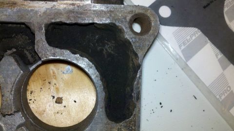 1978 Ford Bronco - Close-up of a used engine part with visible carbon deposits and a gasket from Fel-Pro.